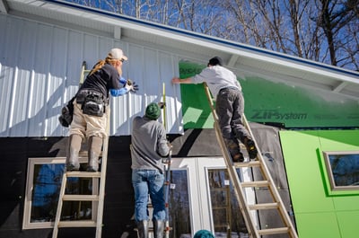 metal crew working on a wall