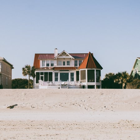 beach house with red metal roof