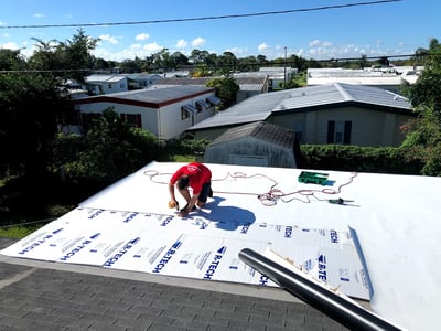 A flat roof being installed by a roofer