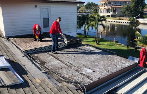 roofers removing a flat deck roof with rotten plywood