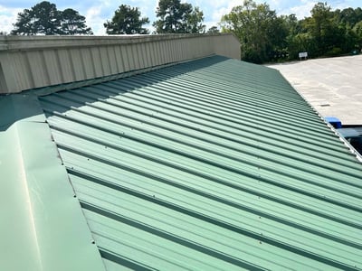 green screw-down r-panel roofing on commercial building
