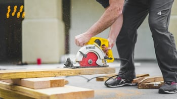 builder sawing wood