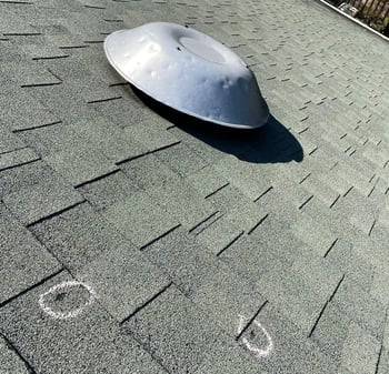 power attic vent and shingles damaged by hail