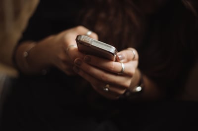 hands holding a phone showing communication
