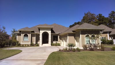 Stucco home with a hip shingle roof