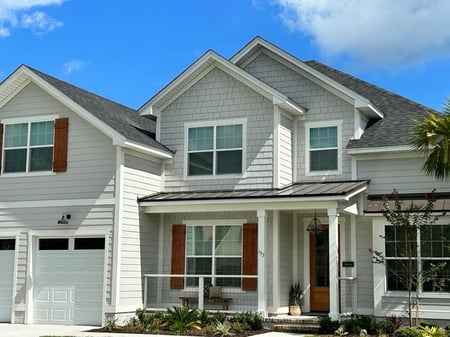 home with shingles and metal accent over front porch