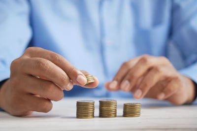 homeowner counting pennies on a table