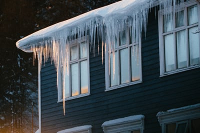 ice sickles hanging from the eave of a roof