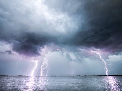 lightening storm over a body of water