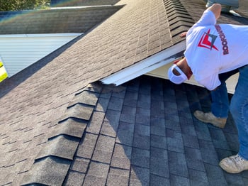 roofer checking the flashing on a wall 