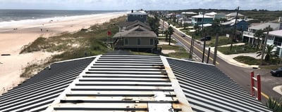 House on the coast with a rusted metal roof 