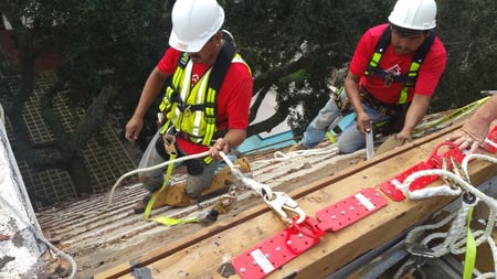 roofers on a steep commercial roof repair