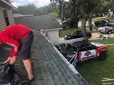 roofer repairing an asphalt shingle roof
