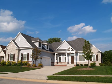 brick and lap siding home with dark gray roof