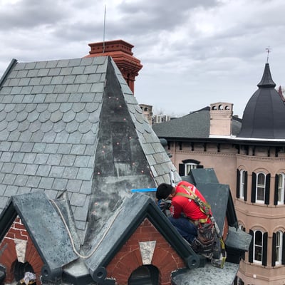 roofer repairing a slate roof