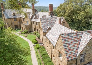 stone mansion with beautiful multi-colored slate roof