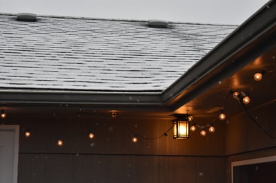 snow and ice on a roof of a home