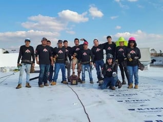 Commercial roofing crew on a TPO roof