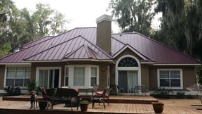 standing seam metal on hip and gable roofline with chimney chase in a valley
