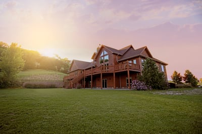 large 2 story home with a sunrise in the background