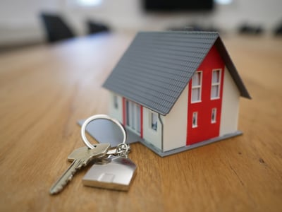 home with red roof and house keys
