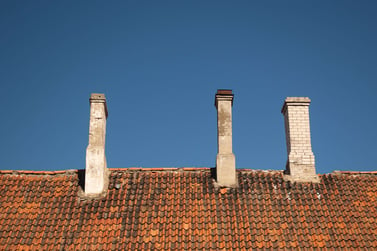 Old tile roof with 3 chimneys