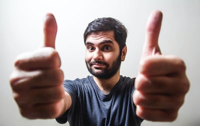Man holding two thumbs up for communication