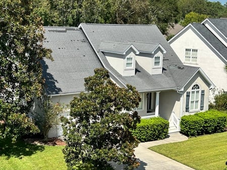 home with wind damaged architectural shingles