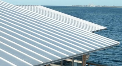 building on a lake with aluminum metal roof