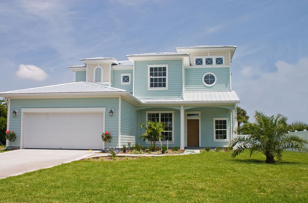 sea foam green house with metal roof