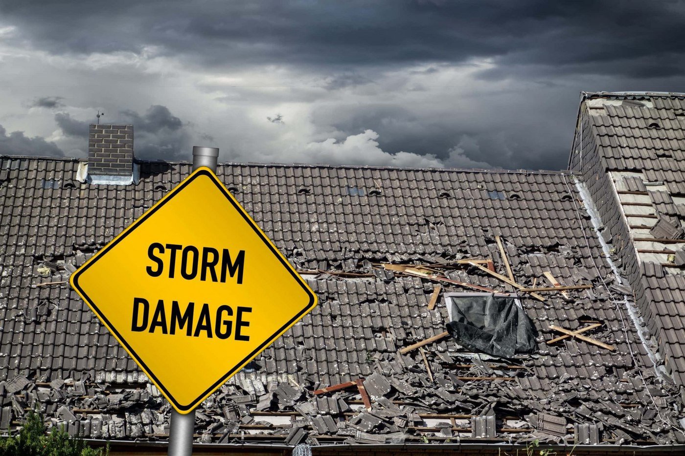 Storm damage caution sign in front of a storm damage tile roof