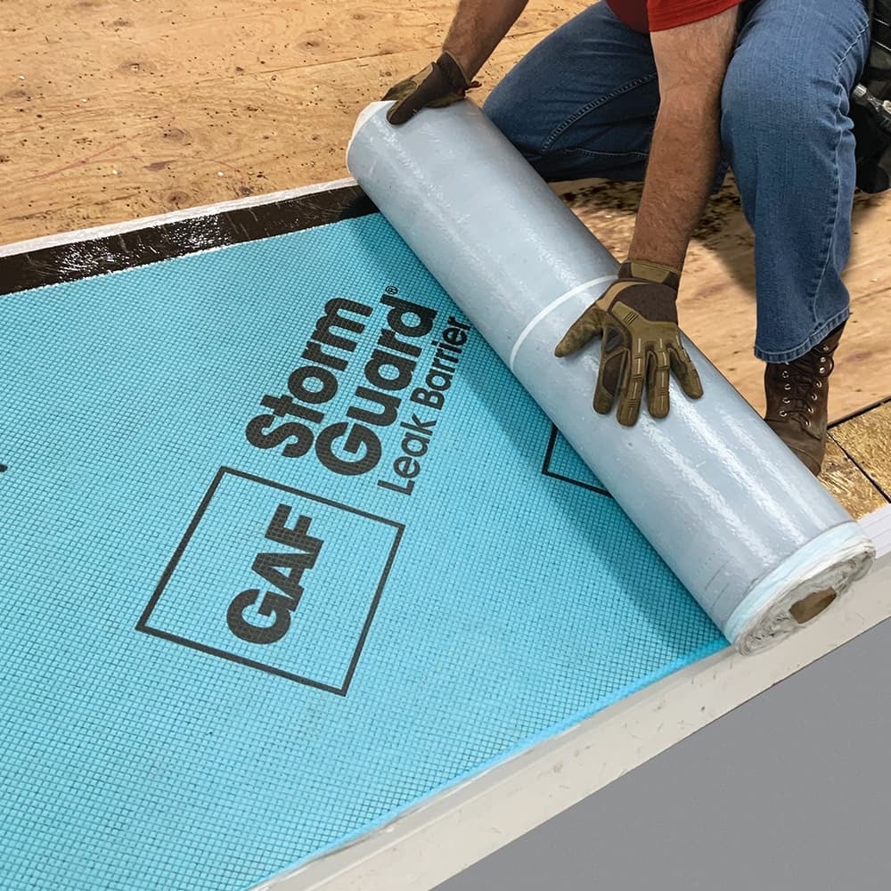 roofer installing GAF storm guard over a plywood deck roof