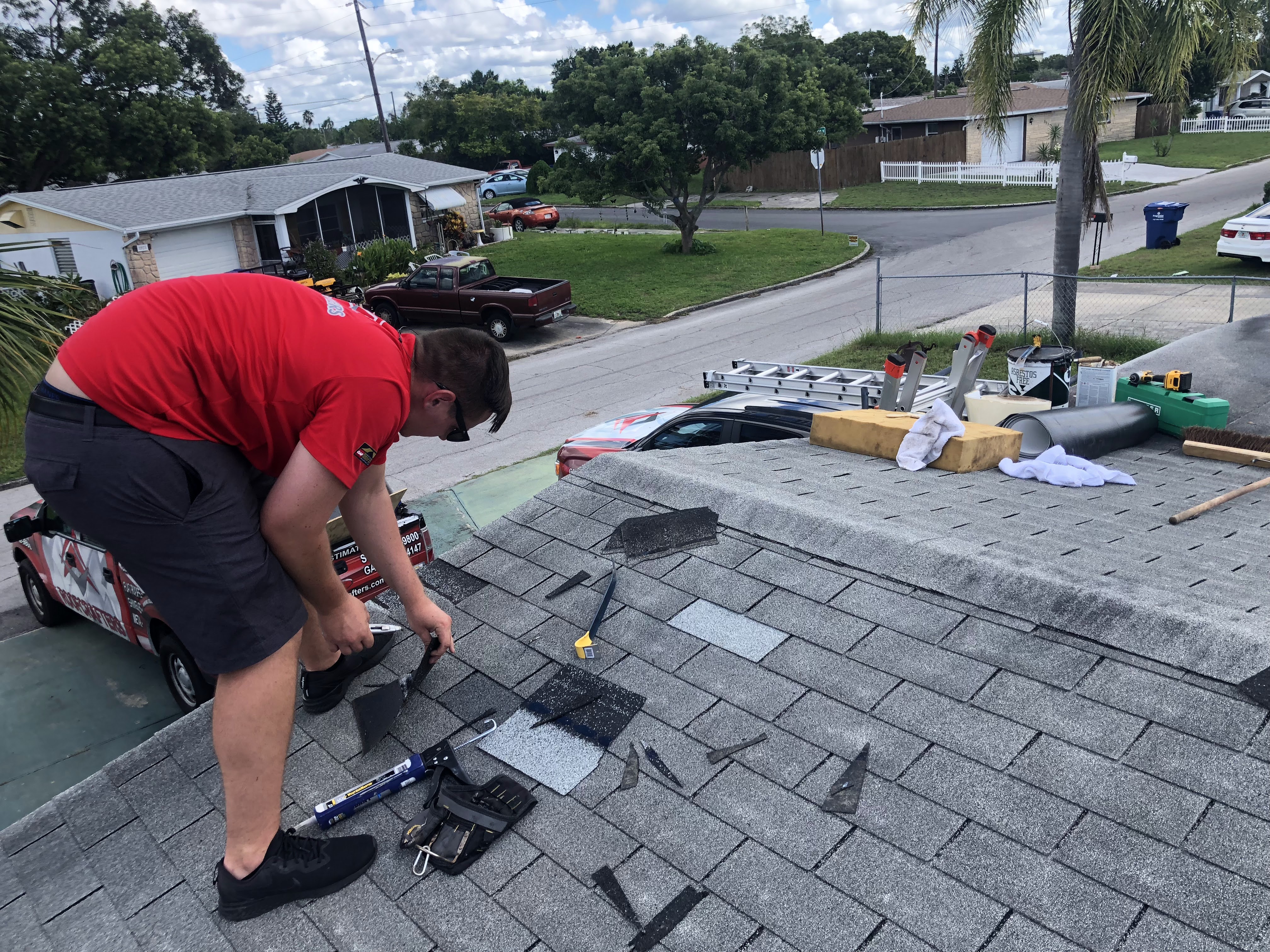 roofer repairing a 3-tab shingle roof