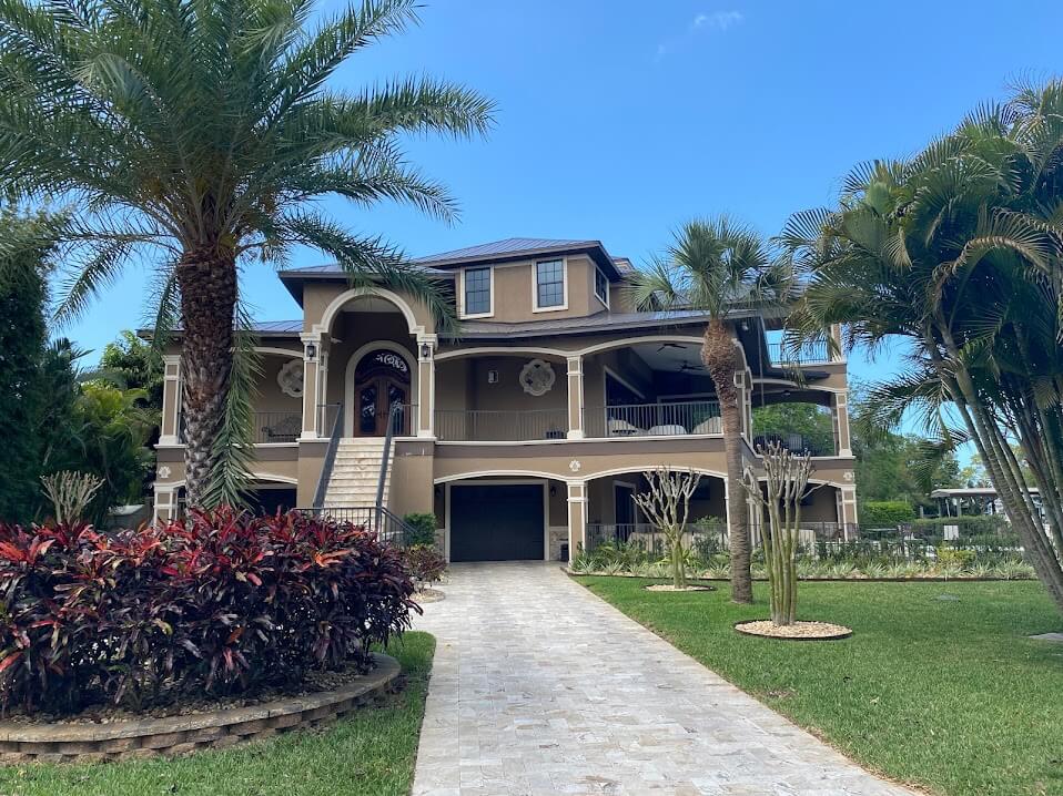 Large beautiful Florida home with a brown metal roof