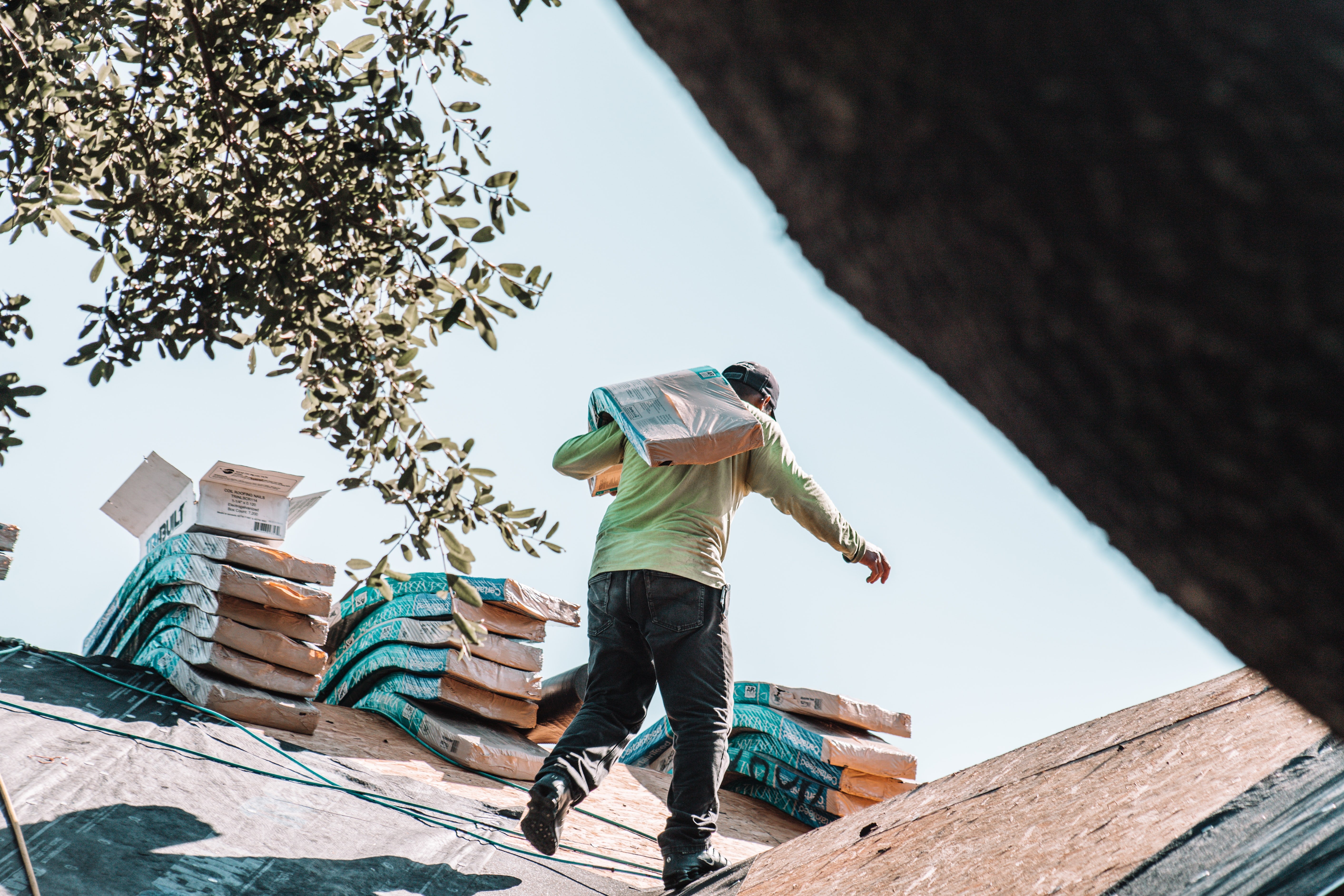 Roofer carrying Certainteed Landmark shingles