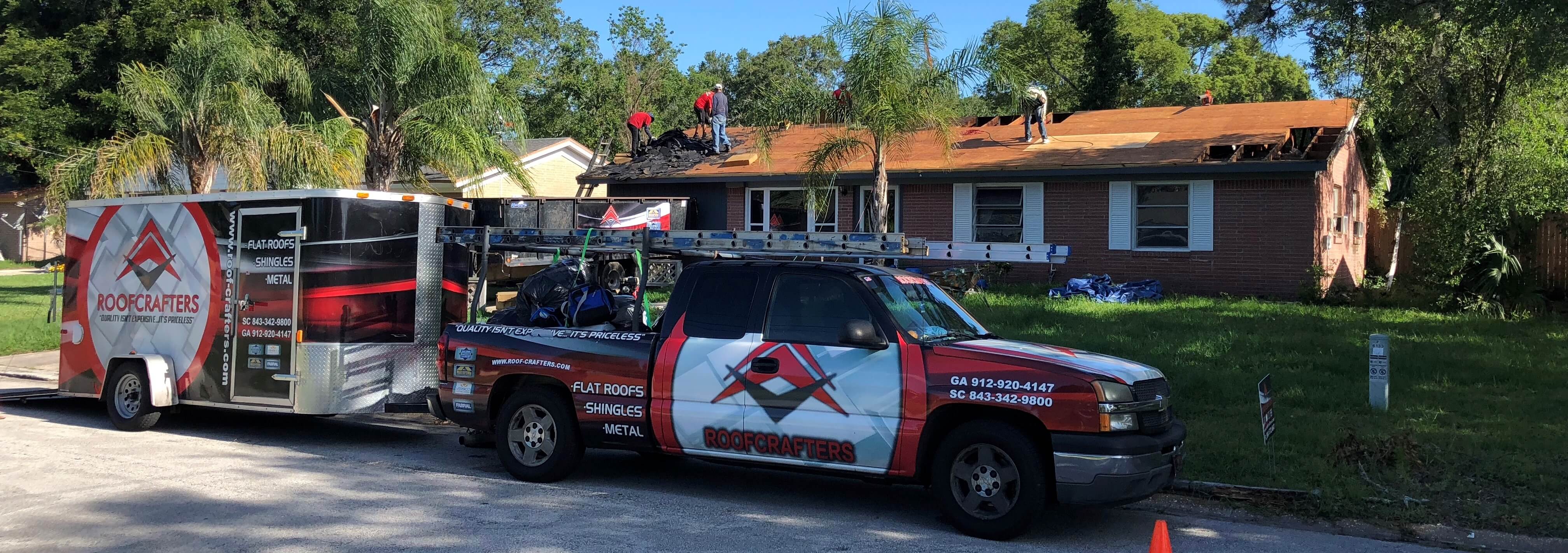 RoofCrafters Truck in front of roof replacement site