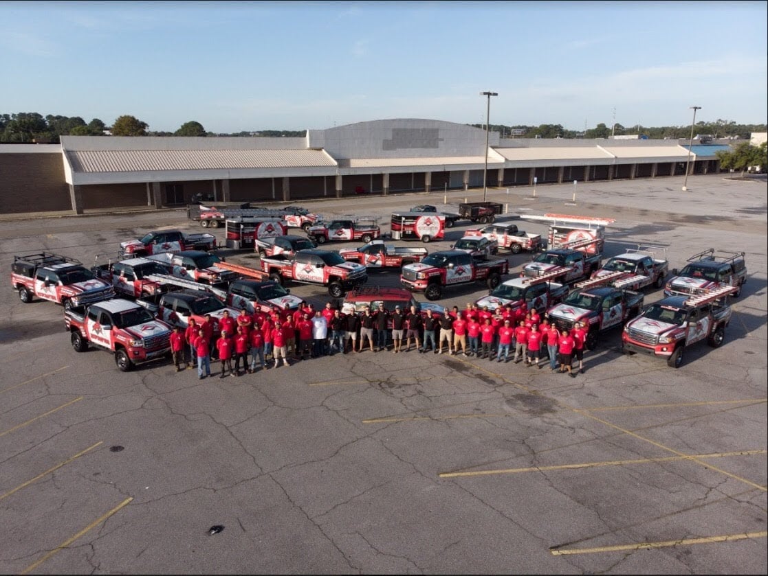 Teammates and trucks in the parking lot at RoofCrafter in Savannah GA