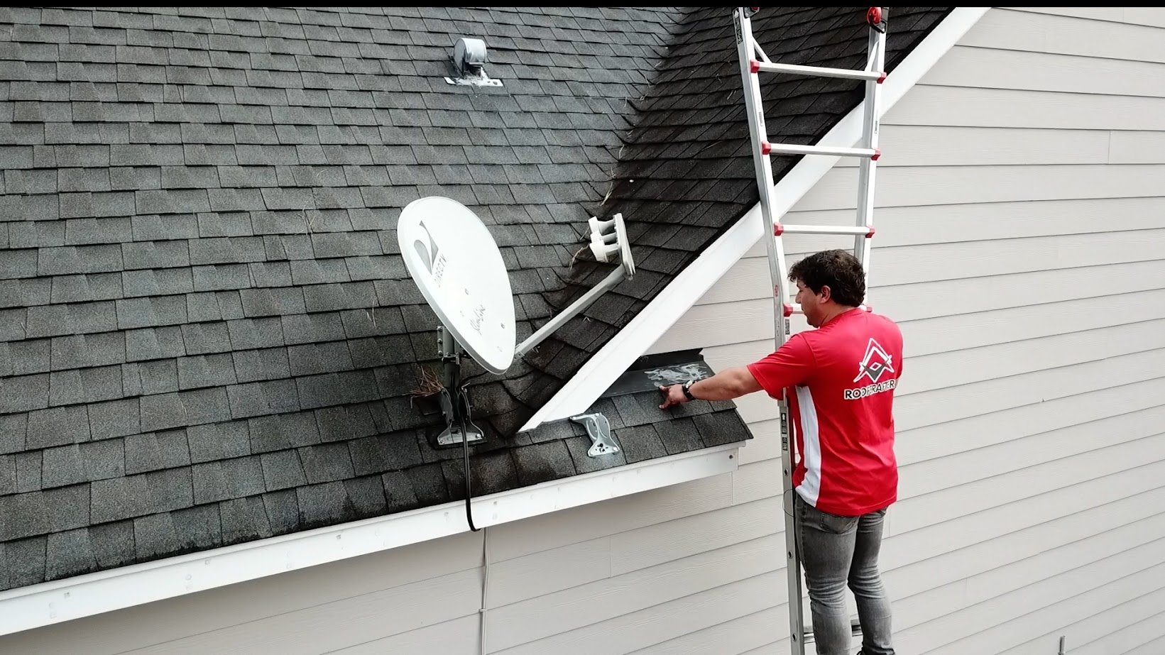 Roofcrafters estimator inspecting a roof on a ladder