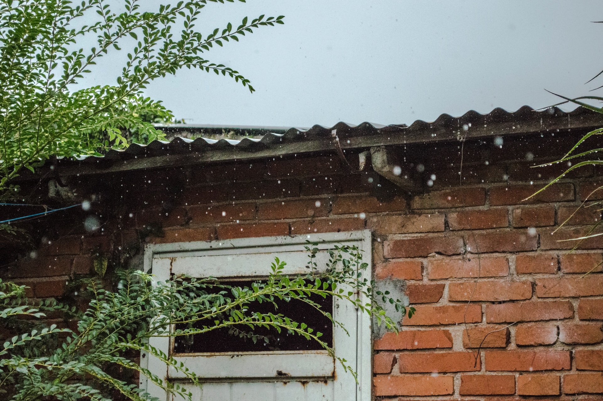 heavy rain on brick house with tin roof