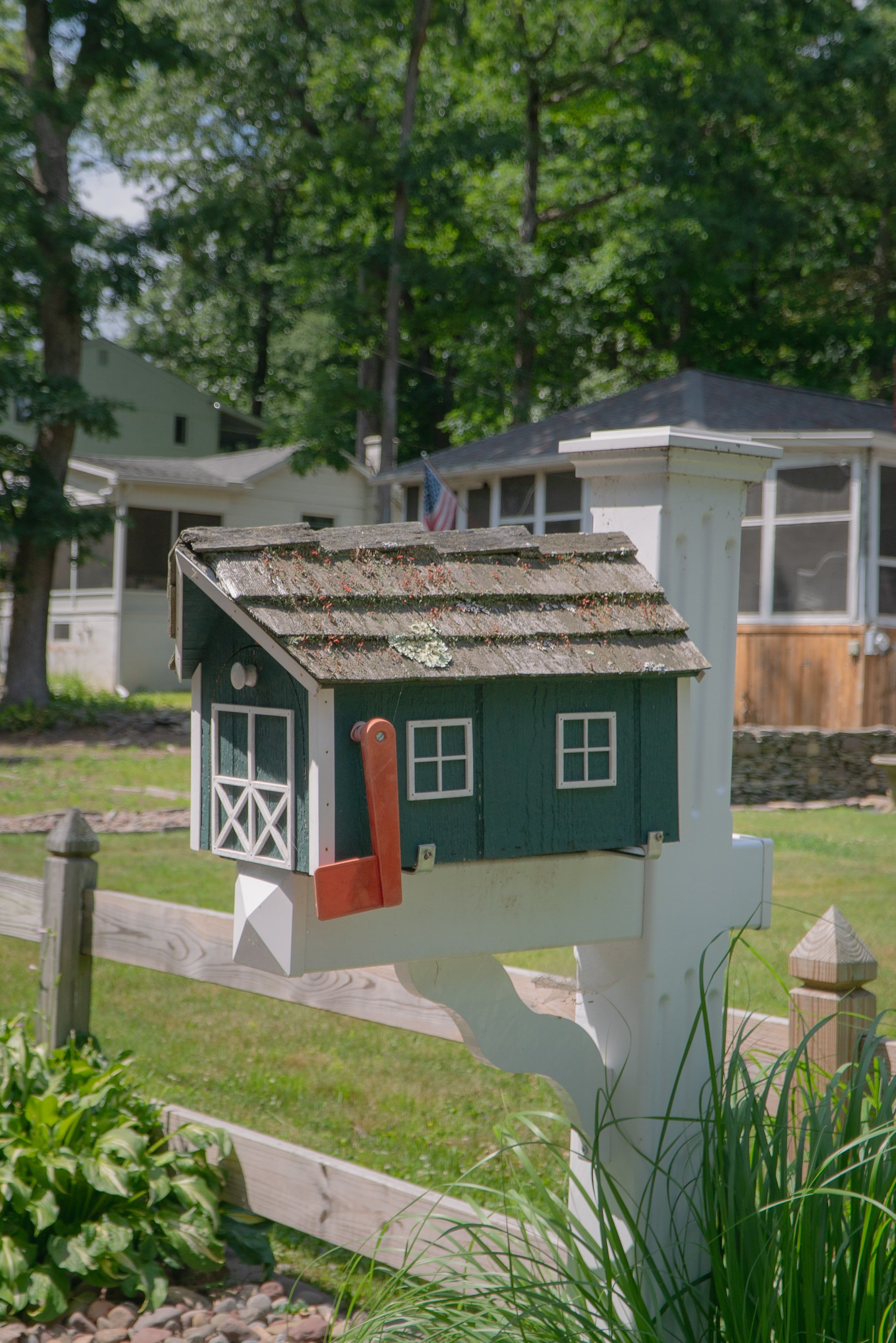 White post mailbox with a wood cedar shingle roof for a top