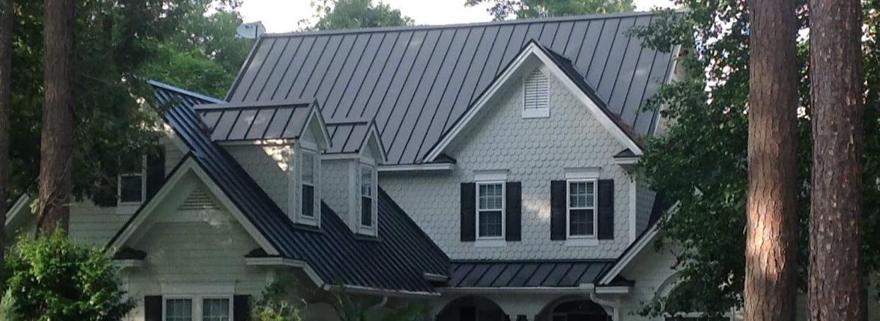 black standing seam metal roof on a beautiful home