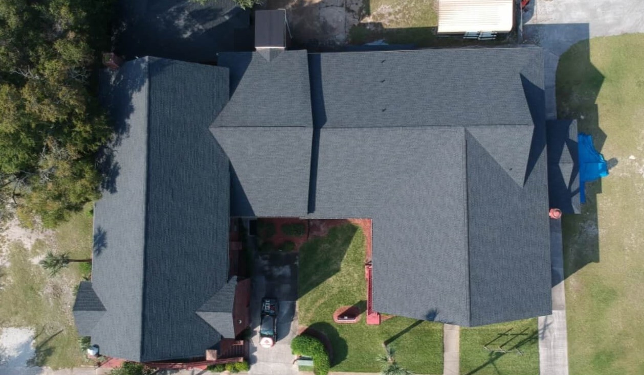 drone shot above a home showing finished 3-tab shingle roof