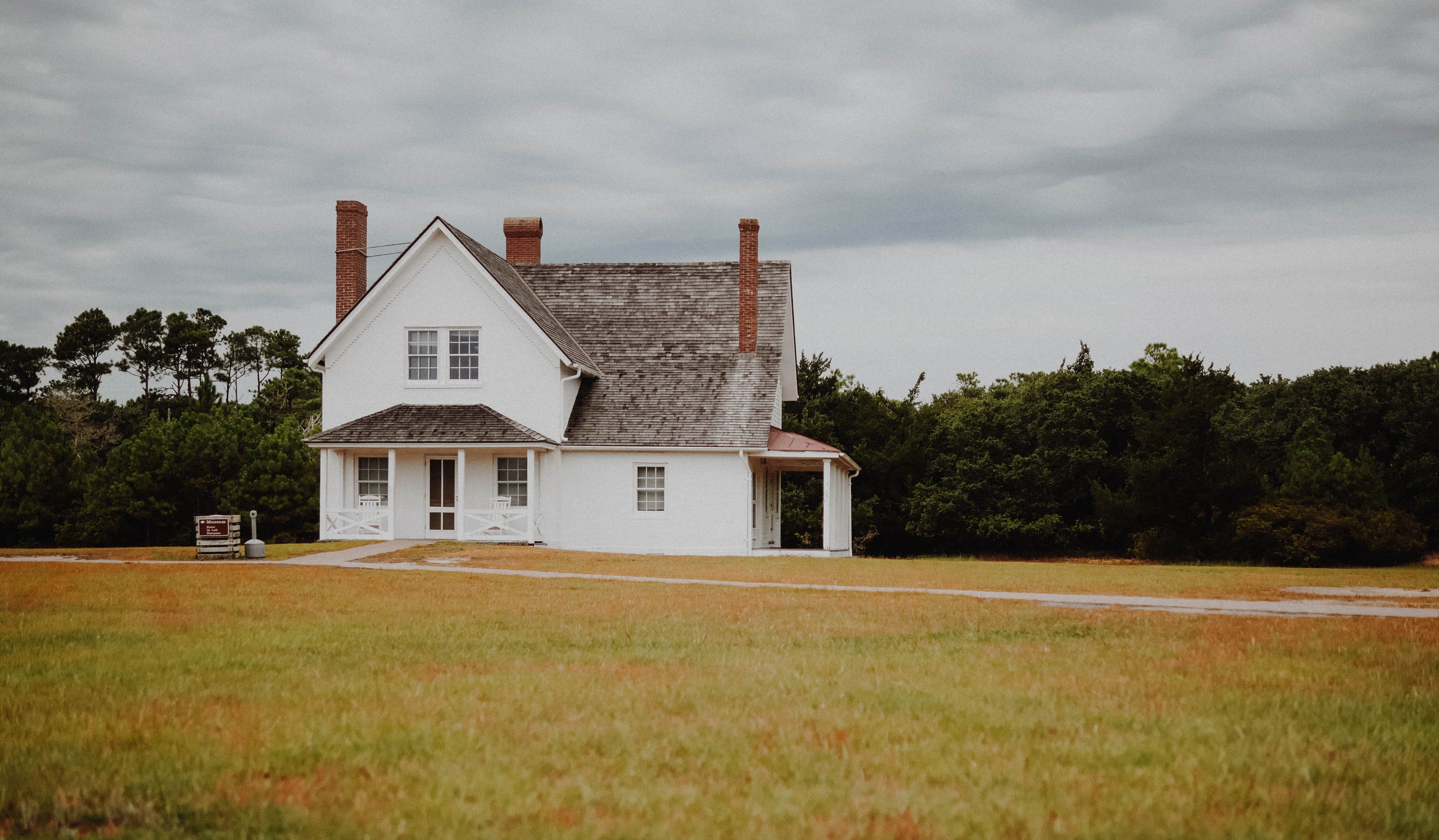 old white farmhouse with shingles