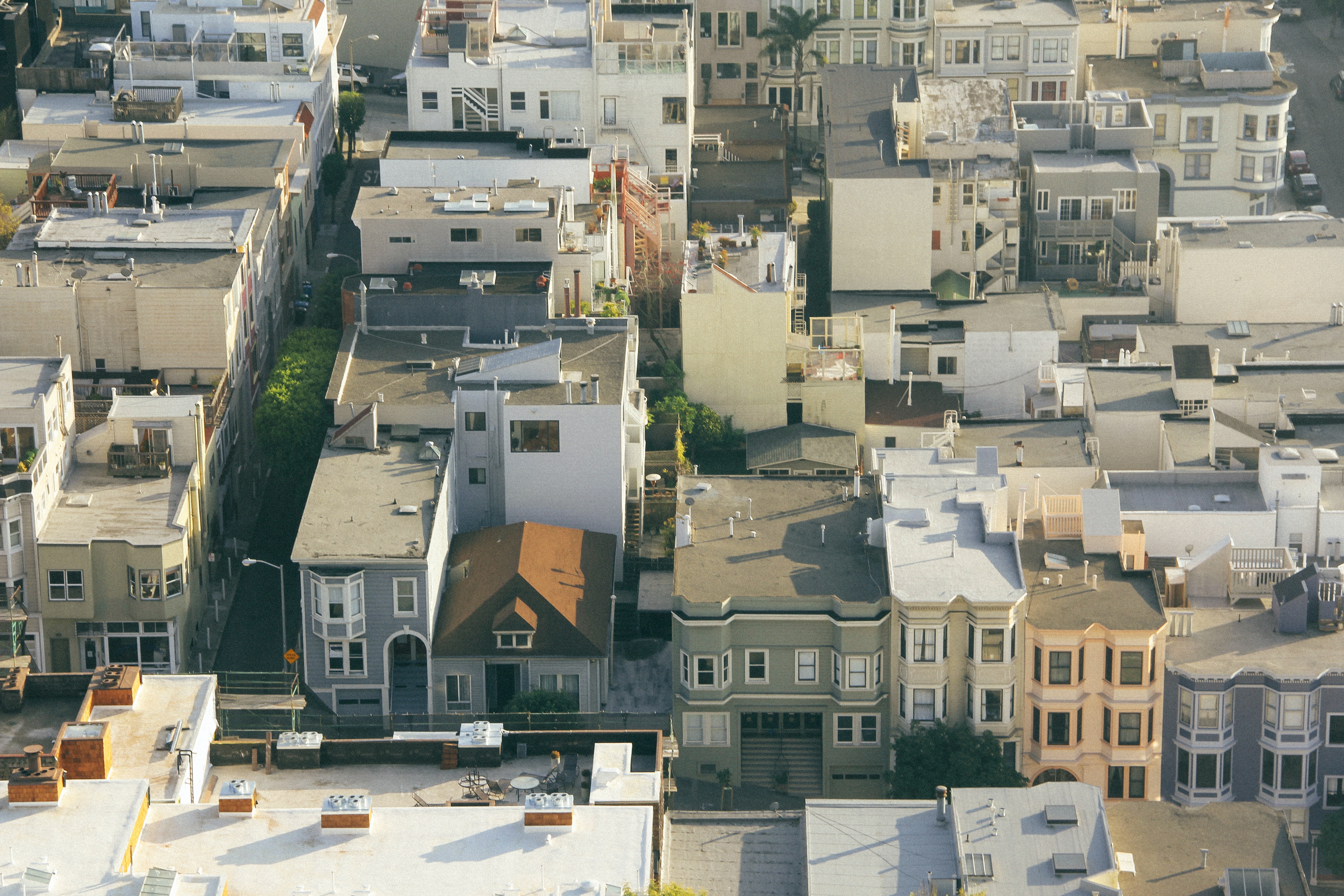 drone view of homes and buildings with flat roofs 