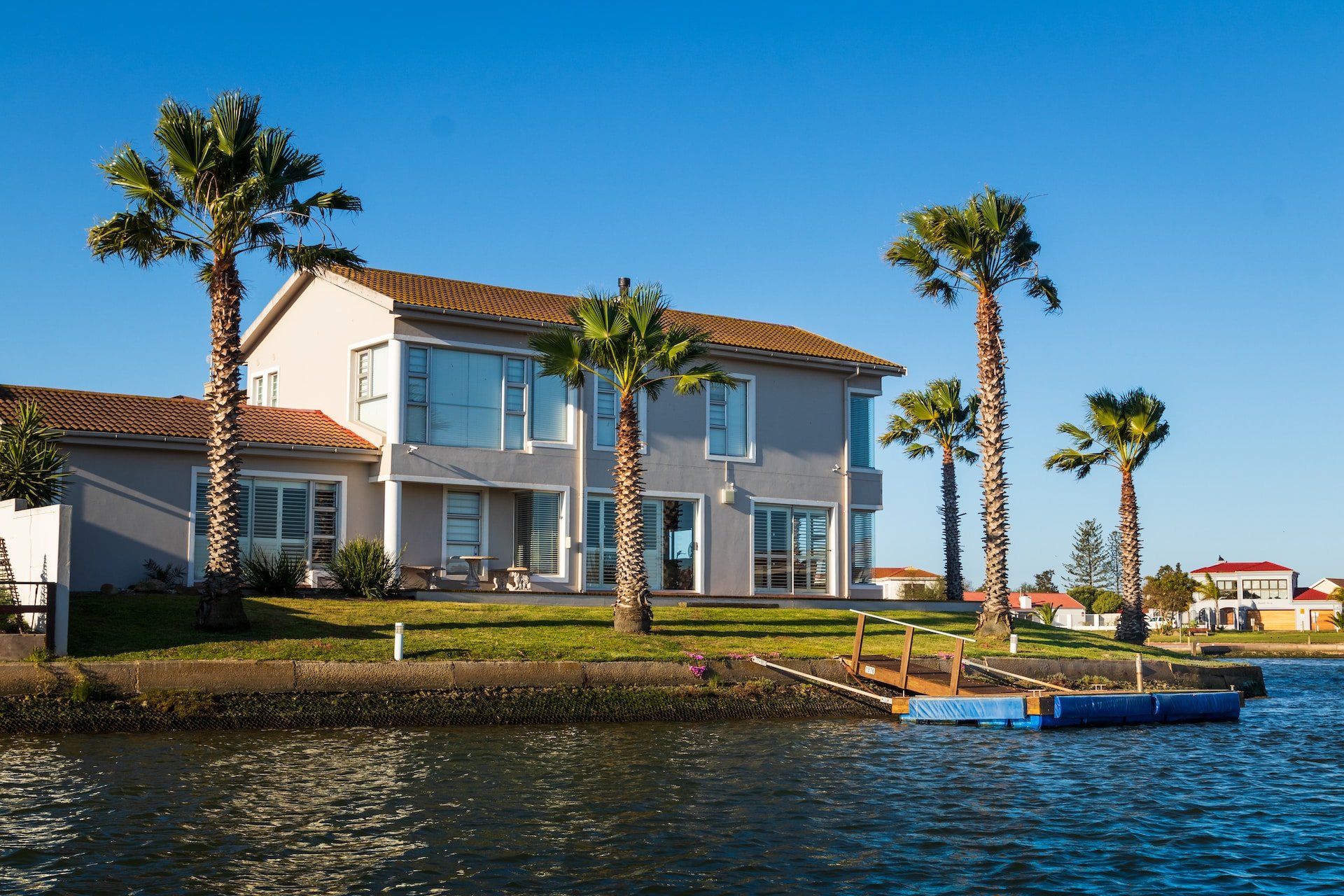 waterfront home with clay roof