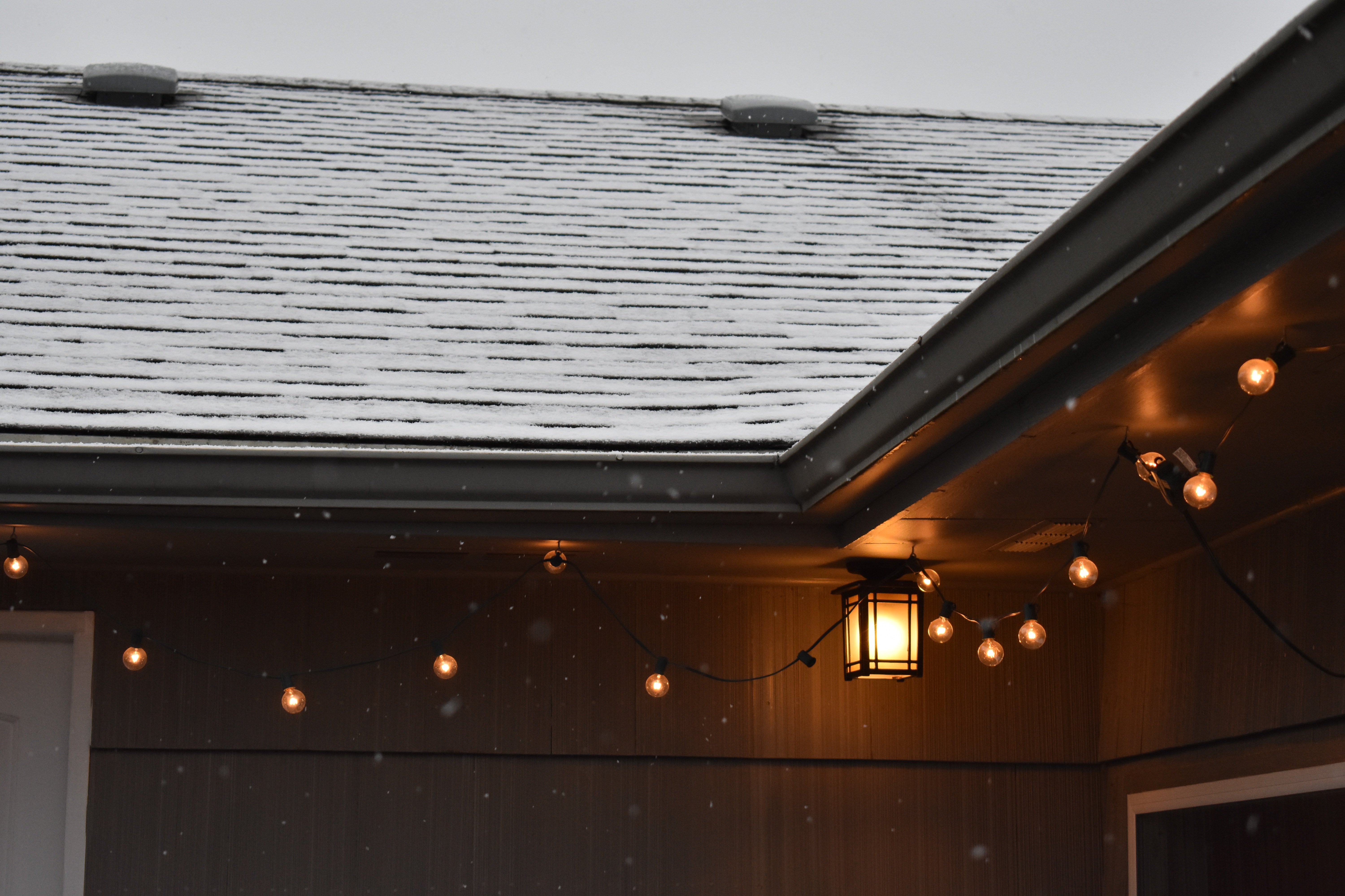 light snow on asphalt shingle roof