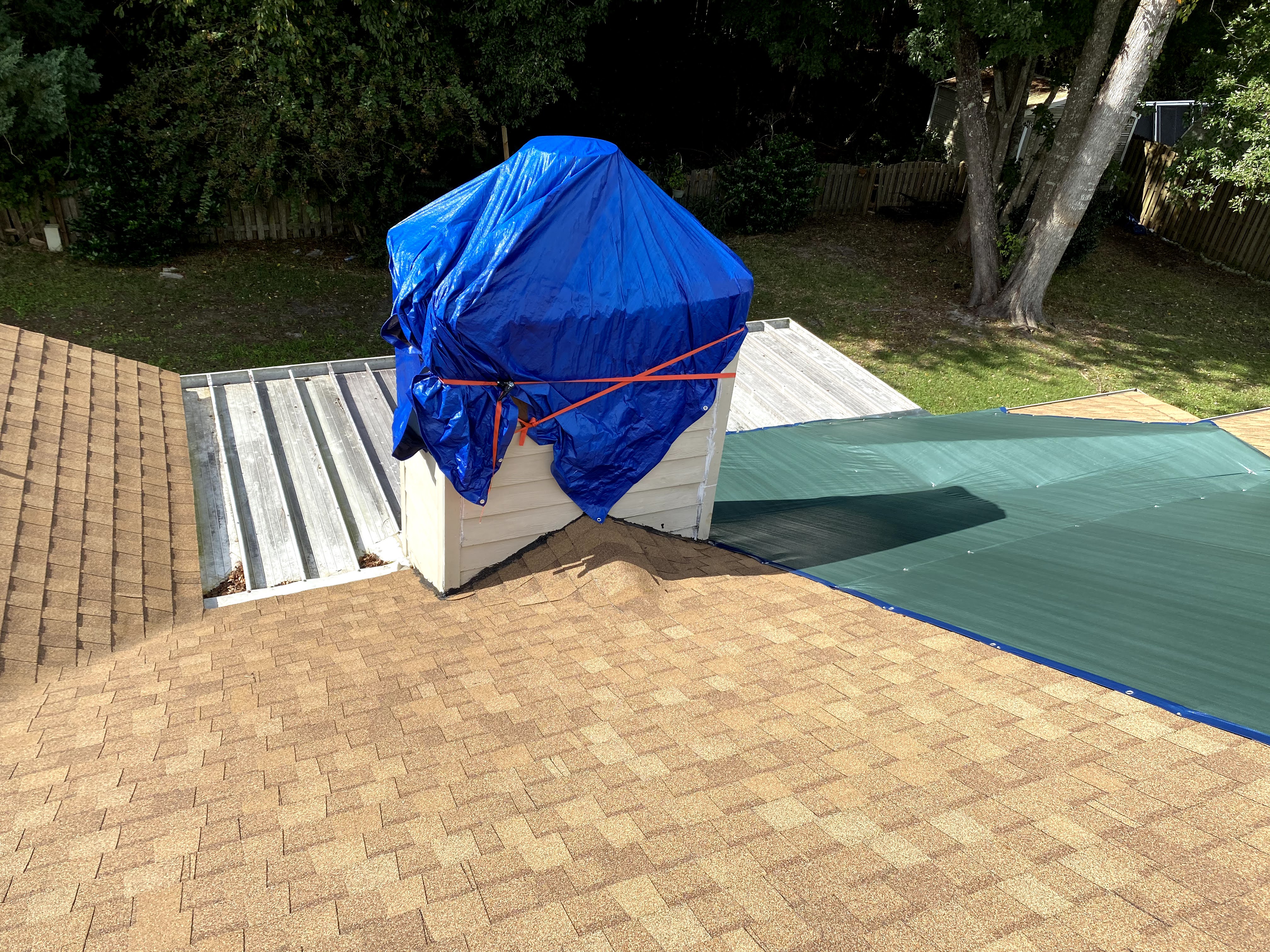 home with tarps on the roof. poor roof installation on a brand new job 