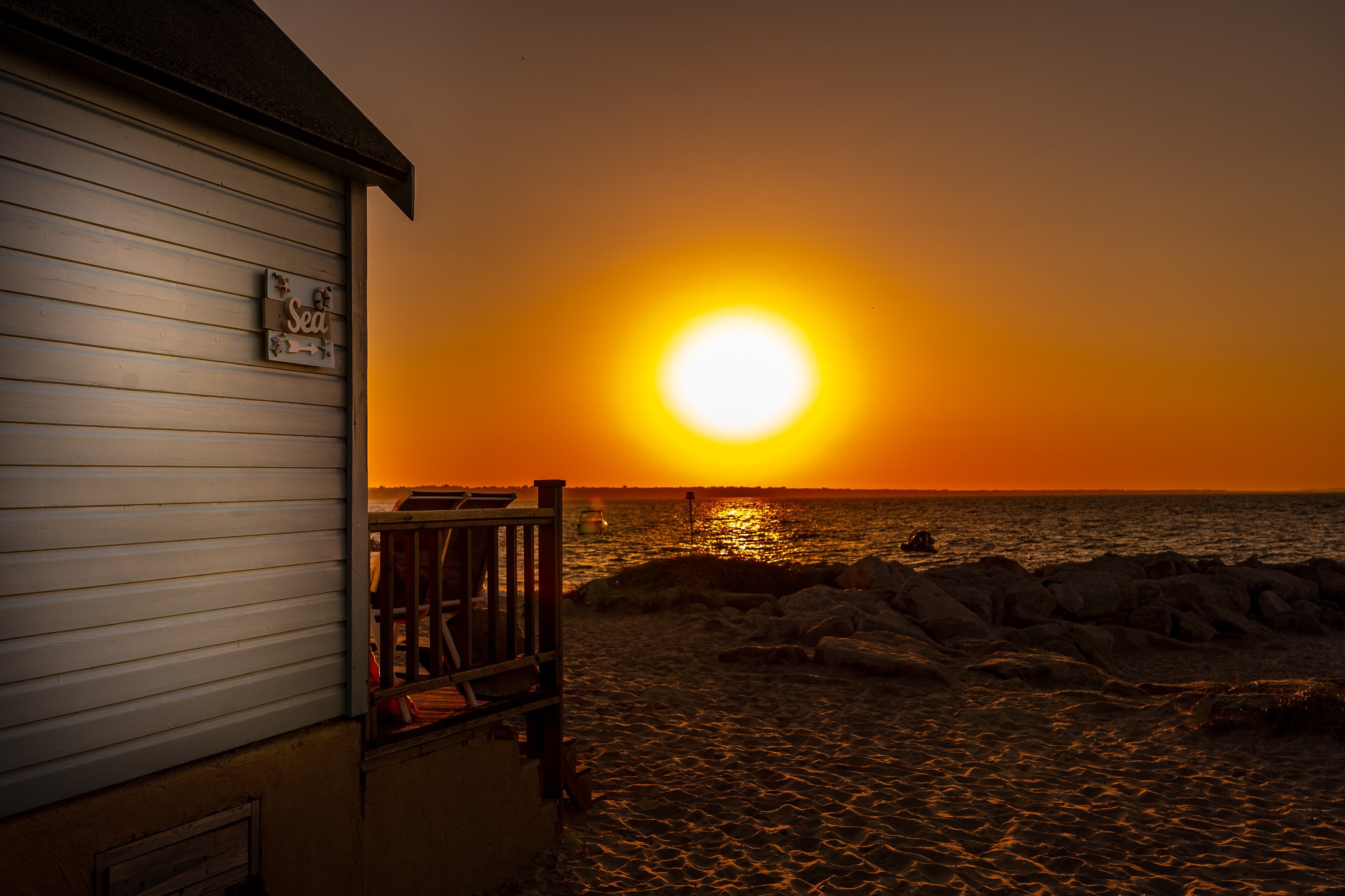 sunrise over the ocean and a beach home