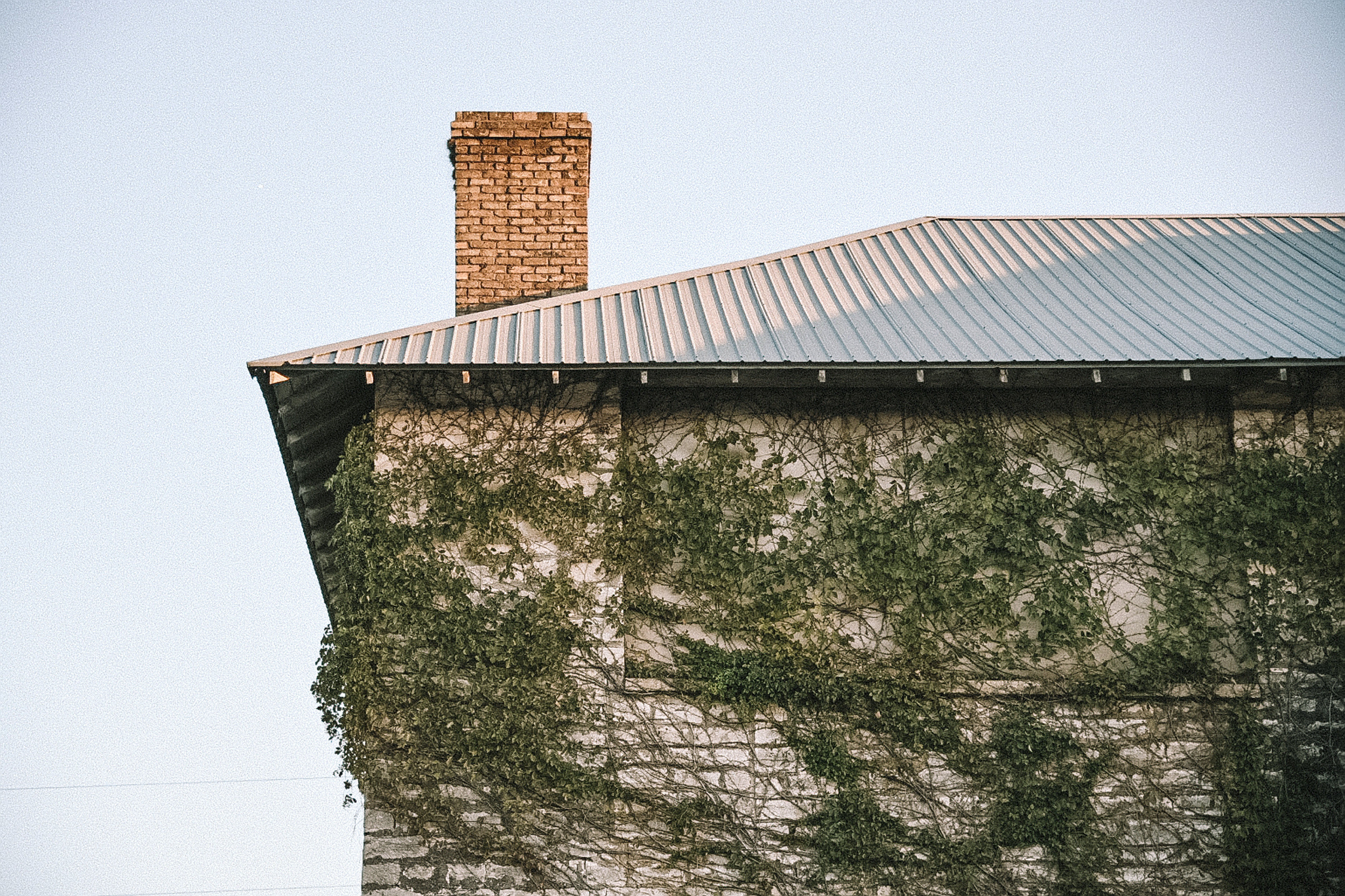 metal roof with brick chimney