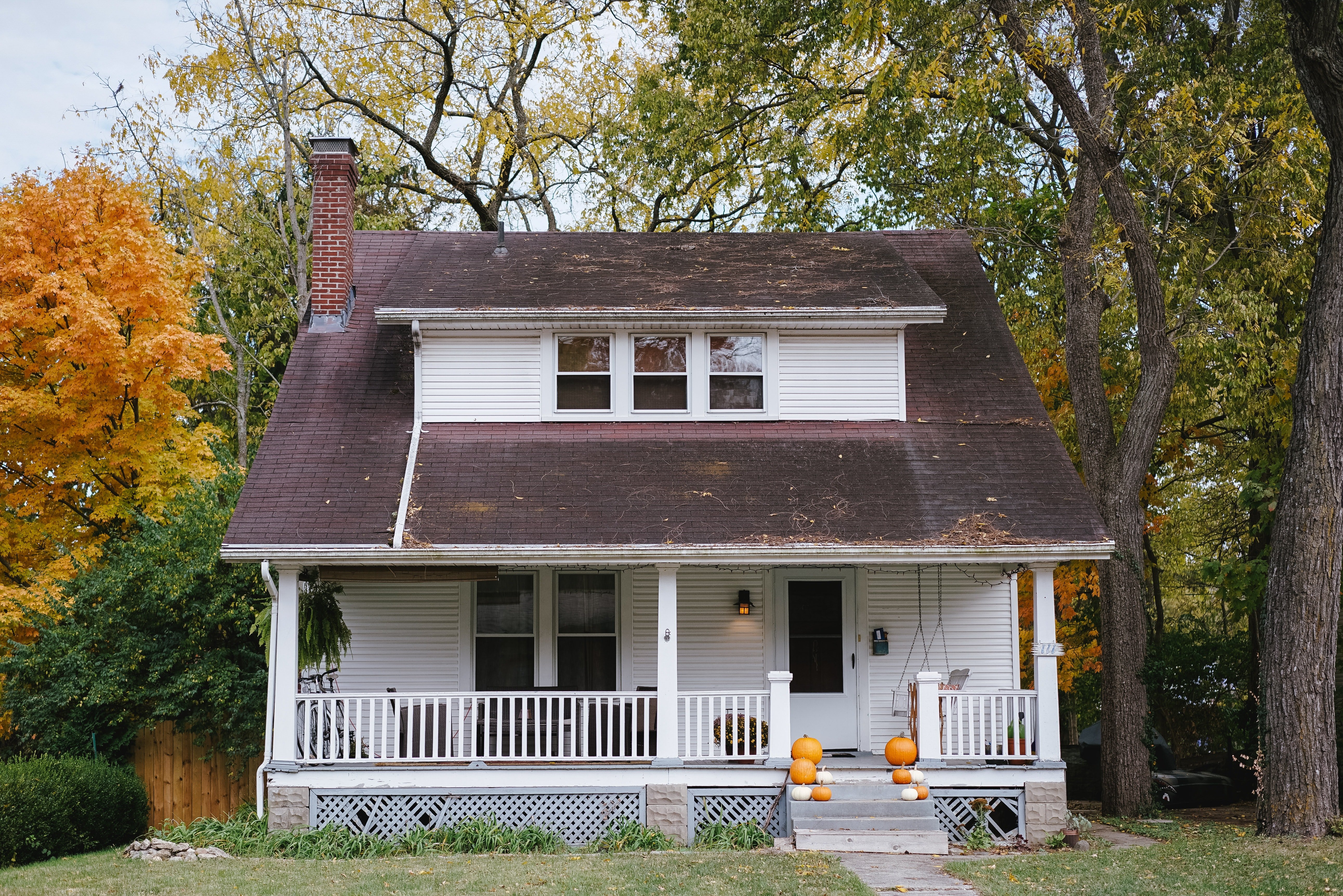 white farmhouse photographed in the fall